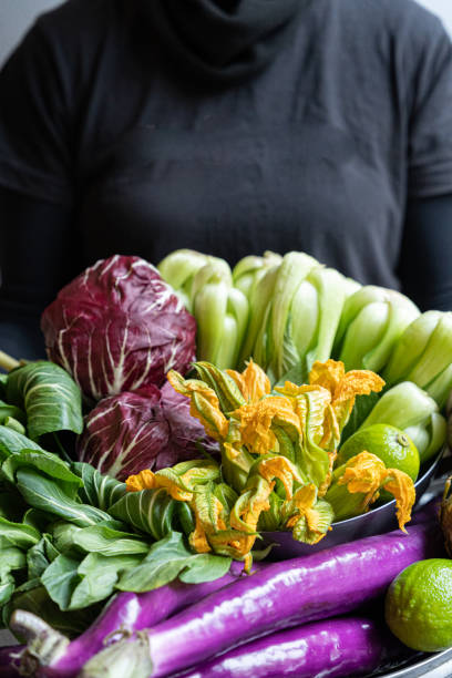 Yellow-orange zucchini flower on a plate on a blurred background in horizontal format