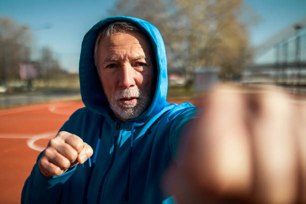 istock Senior boxer shadow boxing outdoors 1395157303