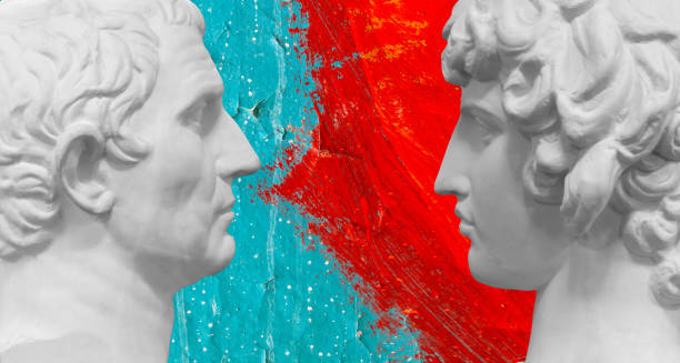 istock two white busts of men facing each other on a red-blue background 1395158668