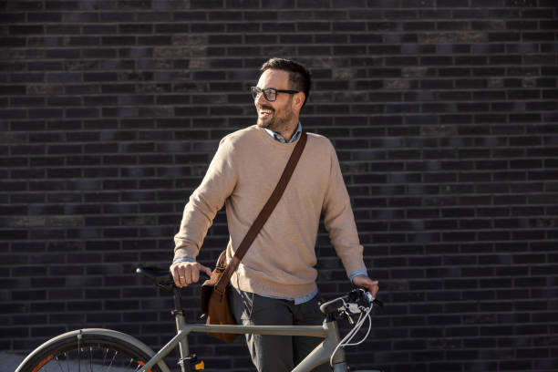 istock A city man pushing bicycle on the street. 1395159028
