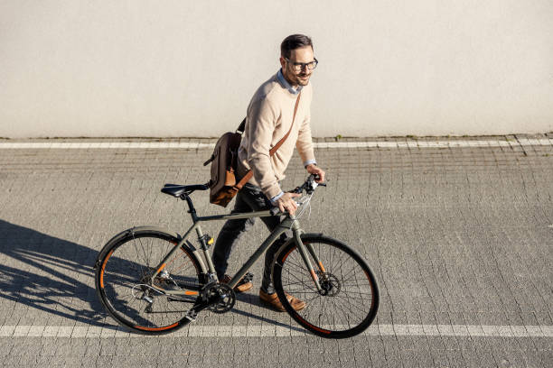 istock An environmentally conscious man pushing his bike and going to work using zero waste. 1395160845