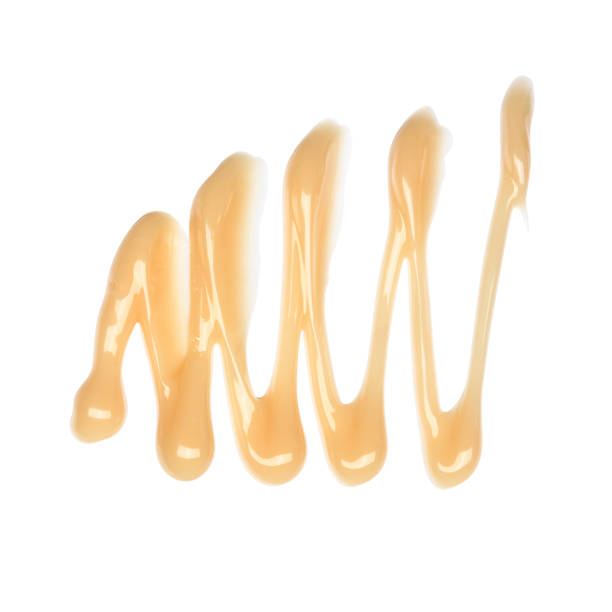 istock Pastel orange cosmetic body lotion sample isolated on white background 1395161929
