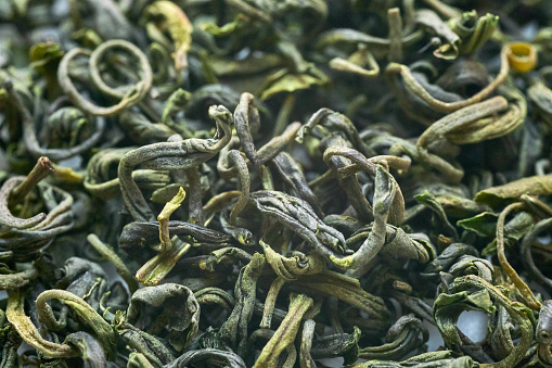 Chinese green tea dry leaves macro, view from above,