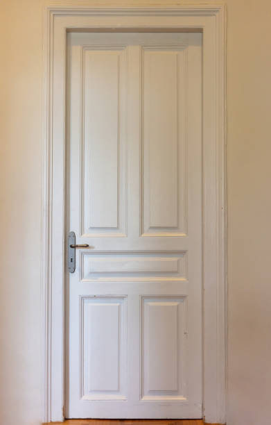 istock Closed door on house wall background. Interior retro white tall door, front view. 1395164038