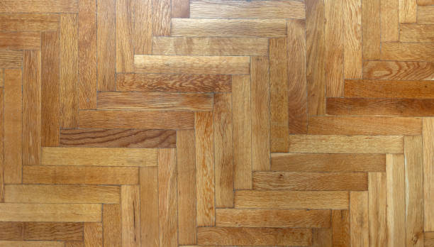 istock Herringbone pattern parquet wood floor texture. Wooden oak flooring background, overhead 1395164073