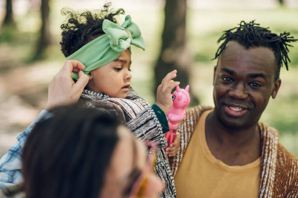 istock Multiracial family having fun in the park 1395165520