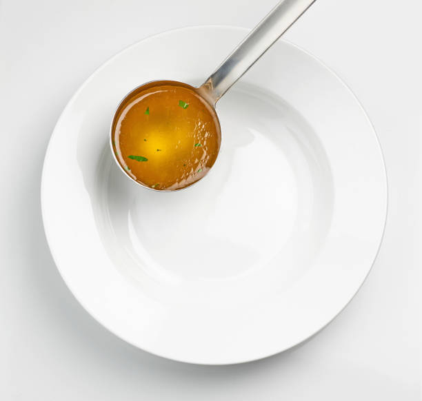 istock empty white soup plate and broth ladle 1395165529