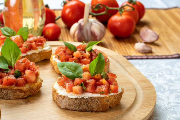 istock bruschetta with tomato, ricotta and basil, on a wooden board 1395166463