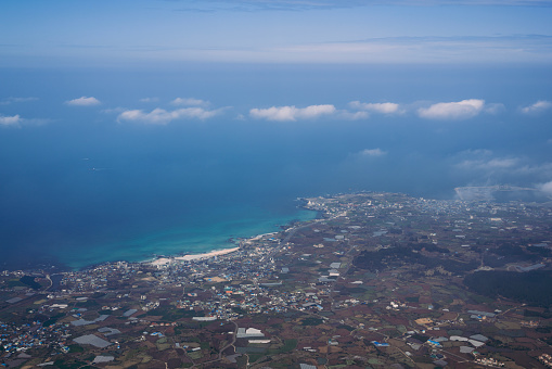 Aerial view of Jeju island and sea from airplane