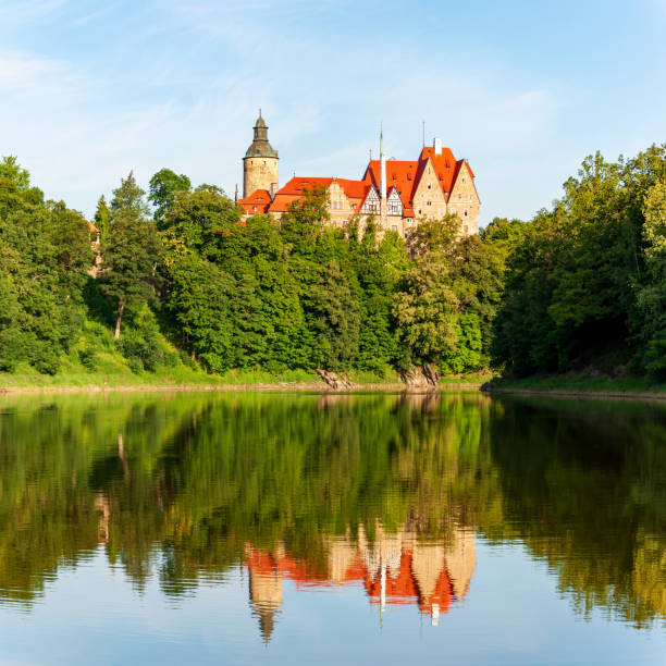 Czocha, Poland - August 2, 2021: Czocha (Tzchocha) medieval castle in Lower Silesia in Poland and its water reflection in Kwisa river. Built in 13th century (the main keep) with many later additions. Summer, early morning