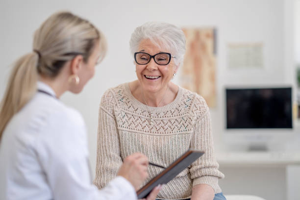 istock Doctor Reviewing Test Results with a Senior 1395169329