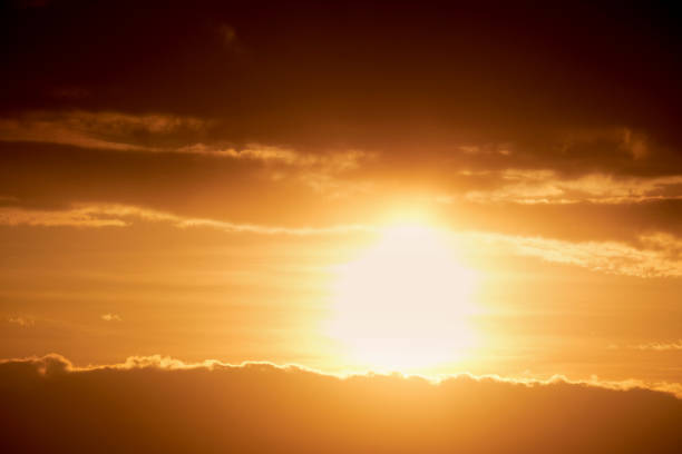 istock Dark clouds in the evening sunset sky with the setting sun. Dramatic sky during orange sunset 1395174095