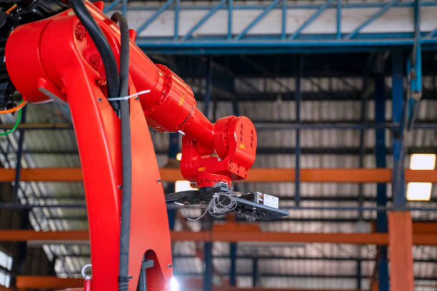 istock Employees are working at factory with robotic arms. 1395174106