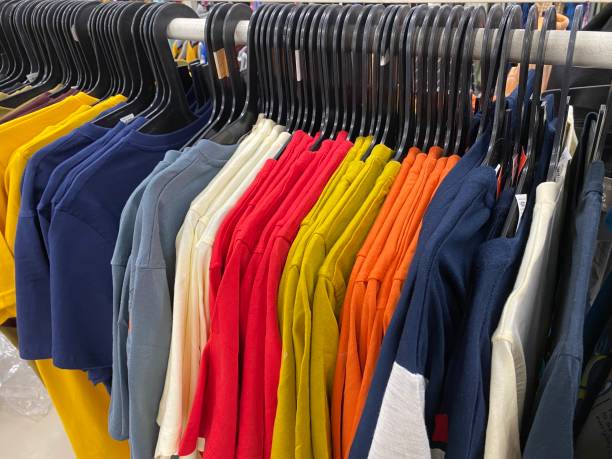 istock Clothes hang on a shelf in a designer clothes store 1395175019