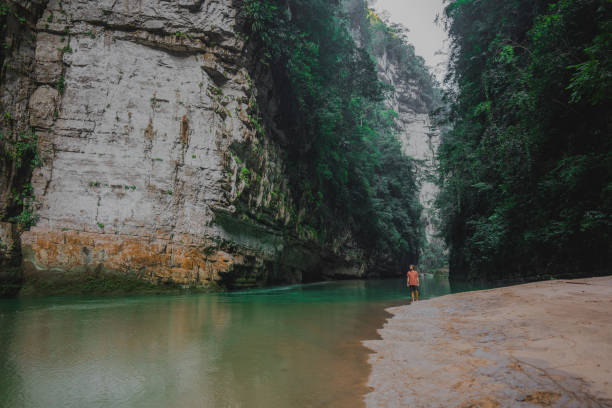 istock Man walking near the turquoise river in  Mexico 1395175105