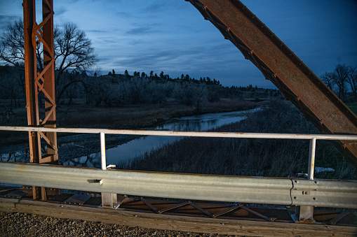 Backgrounds - at sunset, one lane bridge over the Musselshell River at Buffalo Trail in central Montana in northwestern United States of America (USA).