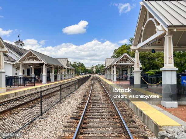 These Commuter Rail Station Platforms Which Also Serve Interstate Rail Travelers Are Located On A Double Tracked Rail Line Next To A Beautiful Urban Park In Winter Park Florida Stock Photo - Download Image Now