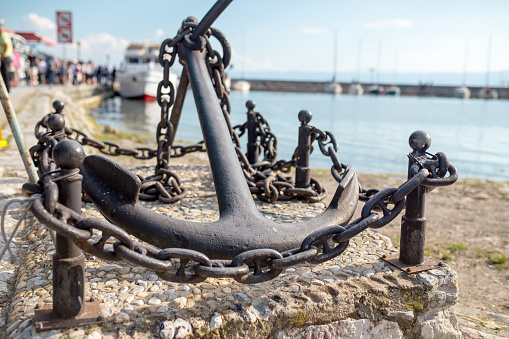 Mooring rope and bollard on sea water and yachts background