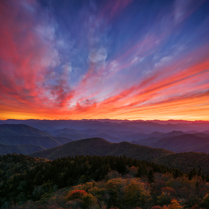 A square composition of a dramatic autumn sunset over the Blue Ridge Mountains of North Carolina