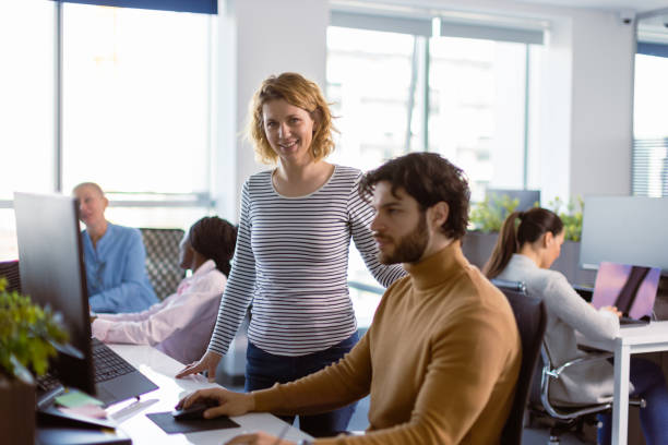 istock Female team leader working with her team 1395180458