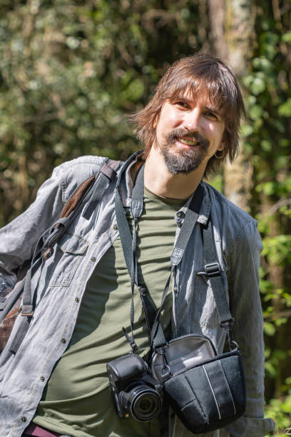 istock happy photographer looking at the camera. 1395181068