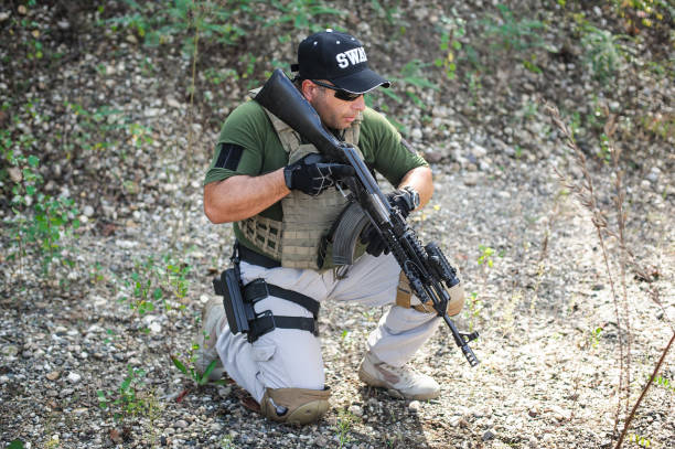 istock Army soldier shooting with rifle machine gun in the forest 1395181794