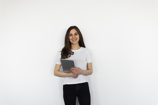 Young woman with a tablet on a white background