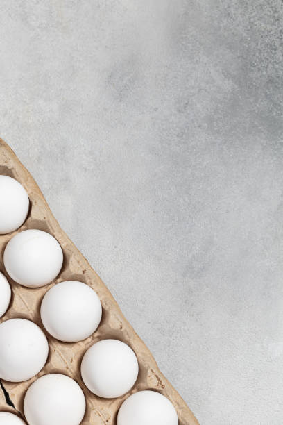istock Packaging of white chicken eggs on a gray background 1395182148