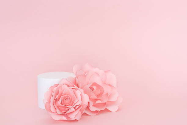 istock Circular white platform for product presentation with roses on pink background. Copy space. 1395183539