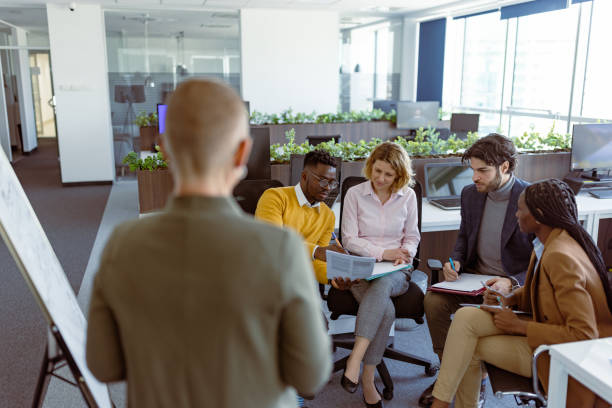 istock Female team leader presenting her business plan 1395183989