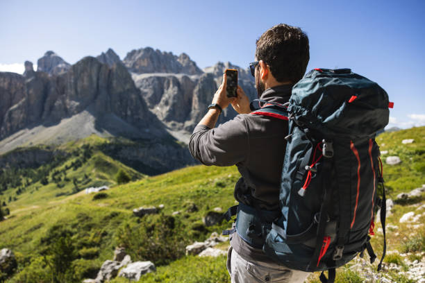 istock Hiking outdoors: on the Dolomites: man photographing with mobile phone 1395184652