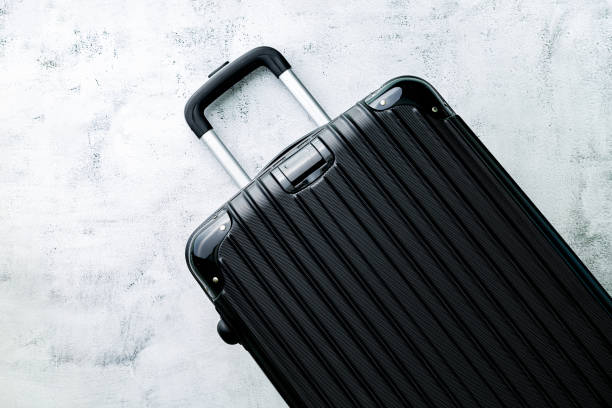 istock Black travel bag,Black luggage set on dark background, top view image, flat lay composition. Travel minimalist concept, black and dark classic baggage mockup, small and big. Suitcase accessory set, journey 1395185554