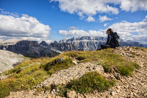 Adventures on the Dolomites: friends hiking together on the mountains of Val Gardena