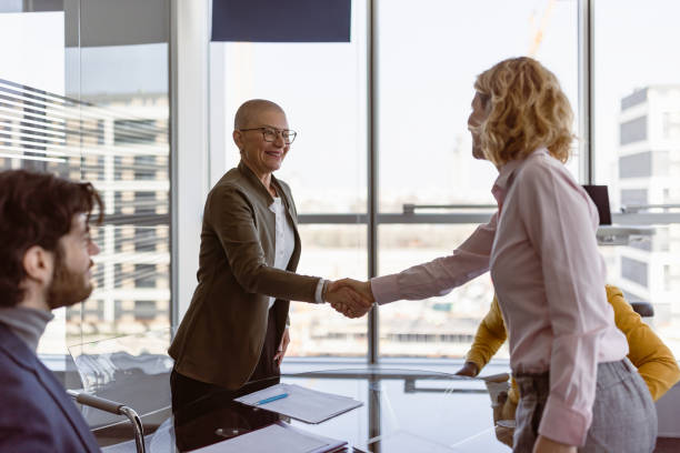 Businesswoman handshake after contract signing stock photo