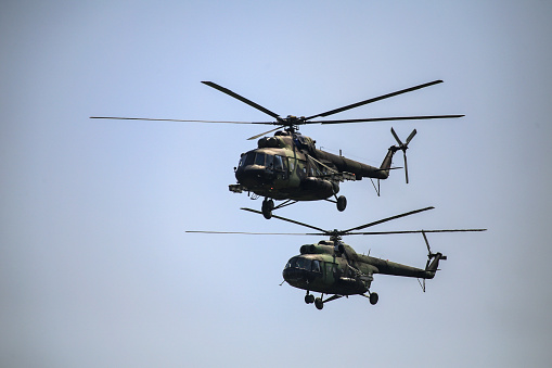 Two military helicopter flying.