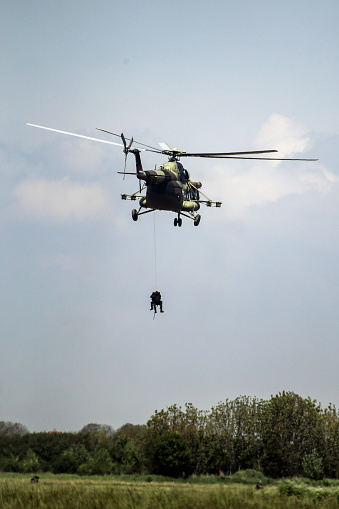 BERLIN, GERMANY - APR 27, 2018: German military NH90 troop helicopter and special forces performing a military demonstration at the Berlin ILA Air Show.