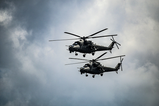 Two military helicopter flying.