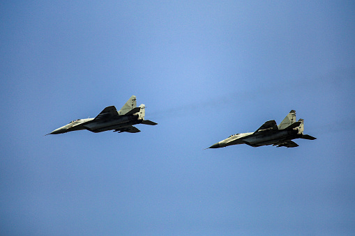 Two fighter airplanes flying during combat.