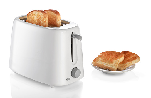 Toaster with bread on white background