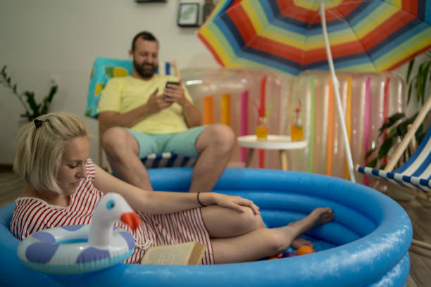 istock Happy couple who cannot go on holiday has fun at home 1395191305