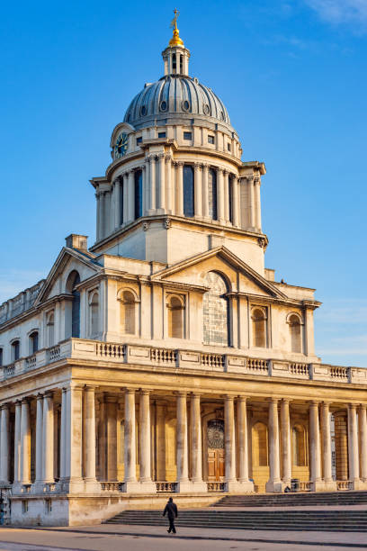 Person walks at the Old Royal Naval College in Greenwhich London England UK on a sunny day, UNESCO World Heritage Site.