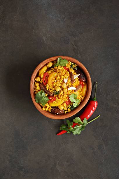 istock Vegan Moroccan Bulgur with Chick Peas, spinach, dried apricots and date fruit. Traditional African Tajine dish. 1395193175
