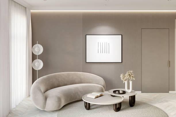 a modern living room in beige tones with a backlit horizontal poster near the door, a floor lamp next to the window with white curtains, and decor on a coffee table next to a modern sofa. - door curtain imagens e fotografias de stock