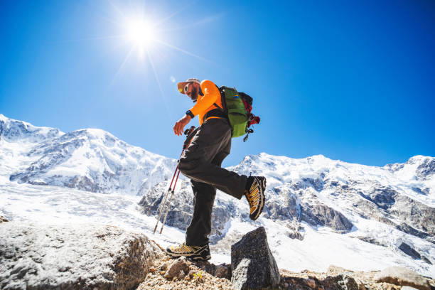 istock One young man trekking in mountains with glacier 1395194628