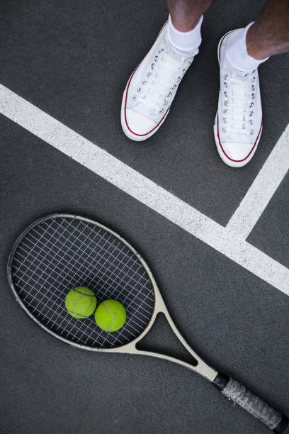 tennis racket ball and athlete's legs on the court top view sports equipment on the court top view tennis tournament stock pictures, royalty-free photos & images