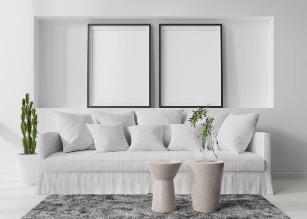istock Two empty vertical picture frames on white wall in modern living room. Mock up interior in contemporary, scandinavian style. Free space for picture, poster. Sofa, table, carpet, plants. 3D rendering. 1395196883