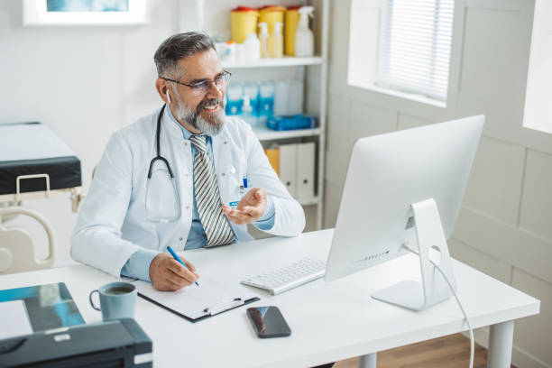 istock Doctor meeting remotely with his patient 1395197432