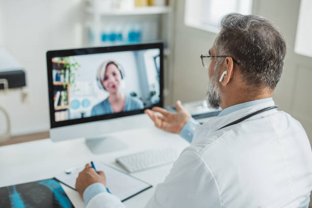 istock Doctor meeting remotely with his patient 1395197474