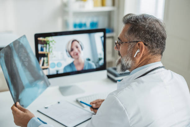 istock Doctor meeting remotely with his patient 1395197490