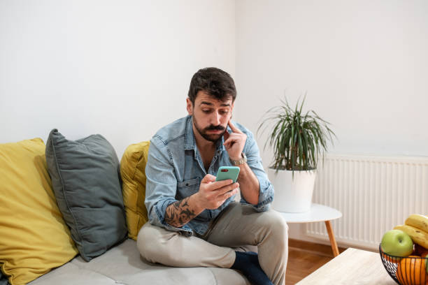 istock Handsome young man confused with what he sees on his phone 1395201949